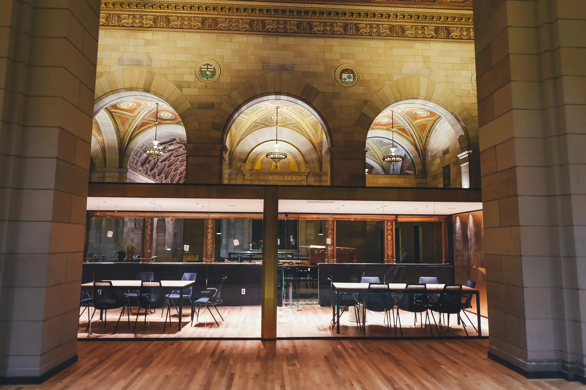 An empty glass-walled meeting room with a long table, in a Montreal office.