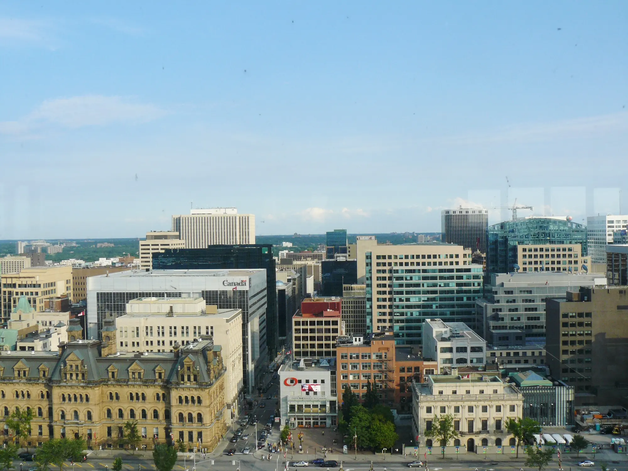 Downtown Ottawa seen from Parliament Hill, with government buildings along Wellington Street and the city beyond.